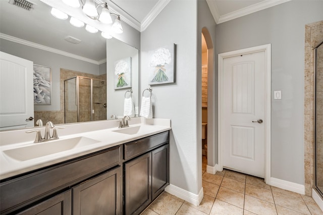 bathroom featuring a shower with door, crown molding, tile patterned flooring, and vanity