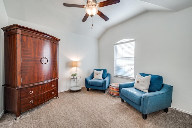 sitting room with ceiling fan, carpet flooring, and vaulted ceiling