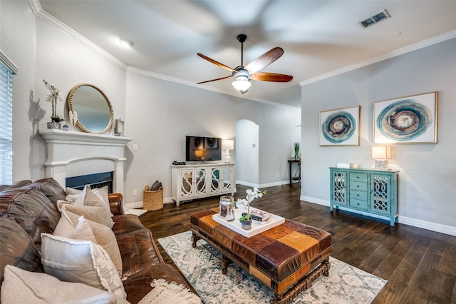 living room with ceiling fan, ornamental molding, and dark hardwood / wood-style floors