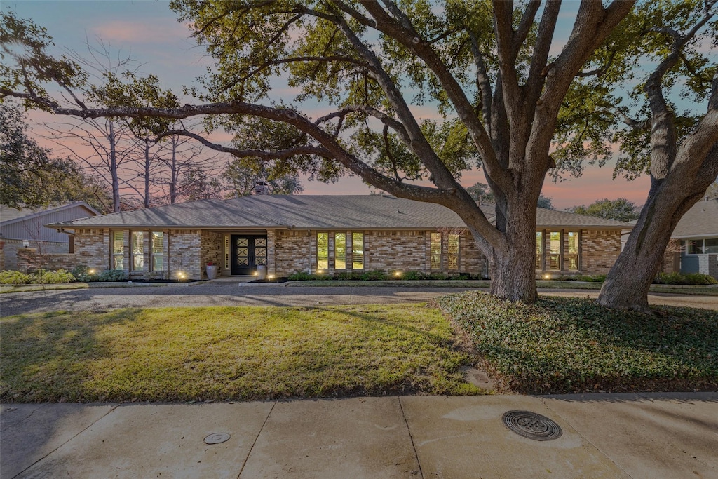 ranch-style house featuring a yard