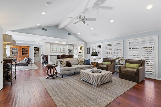 living room with ceiling fan, high vaulted ceiling, hardwood / wood-style floors, and beam ceiling