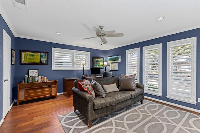 living room featuring crown molding, hardwood / wood-style floors, and ceiling fan