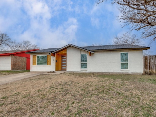 single story home featuring a garage and a front lawn