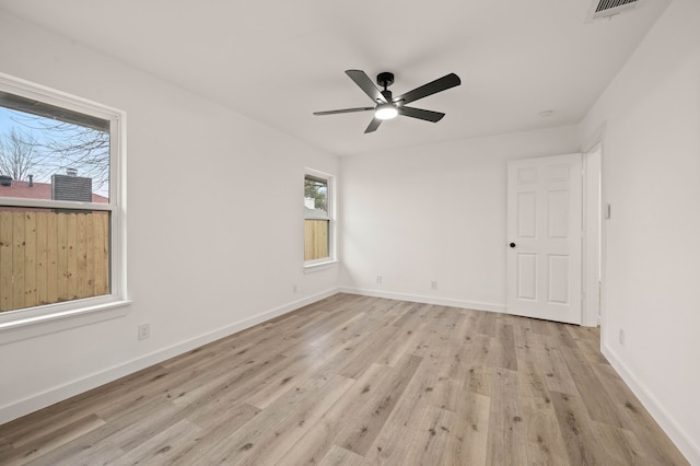 empty room with ceiling fan and light hardwood / wood-style floors