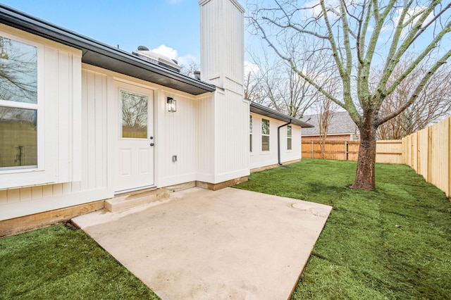 property entrance featuring a yard and a patio area