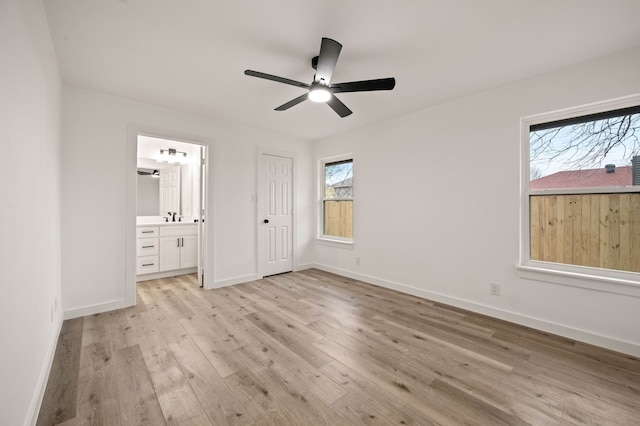 unfurnished bedroom with ceiling fan, connected bathroom, sink, and light hardwood / wood-style floors