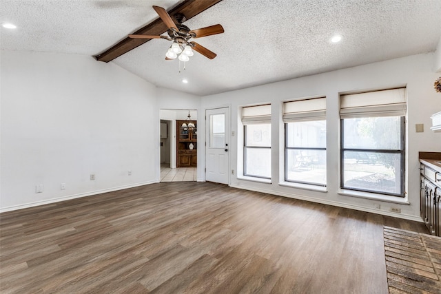 unfurnished living room with ceiling fan, vaulted ceiling with beams, light hardwood / wood-style floors, a textured ceiling, and a brick fireplace