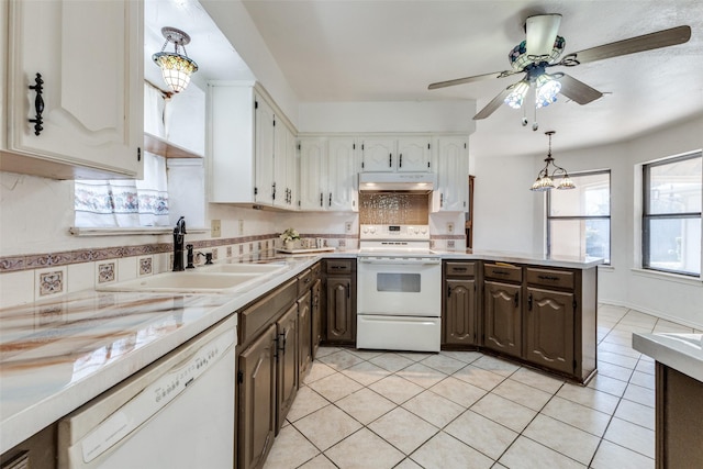 kitchen with decorative light fixtures, white cabinetry, sink, dark brown cabinetry, and white appliances