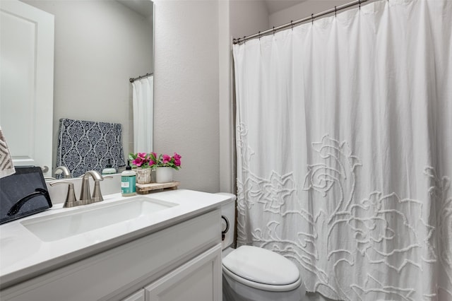 bathroom featuring vanity, a shower with curtain, and toilet