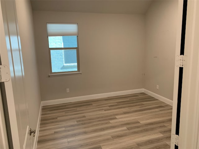 unfurnished room with hardwood / wood-style floors