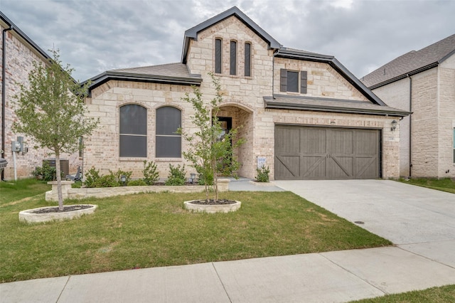 french country inspired facade with a garage and a front lawn