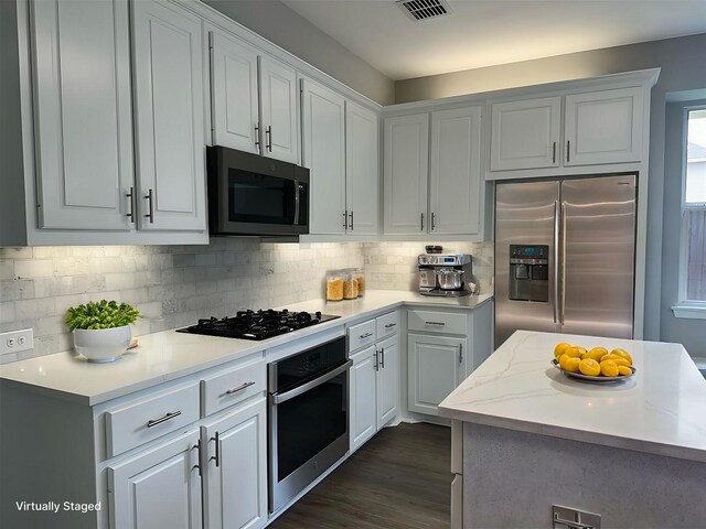 kitchen featuring stainless steel appliances, a center island, and white cabinets