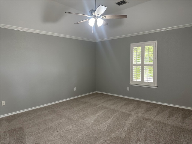 empty room with carpet floors, baseboards, and crown molding