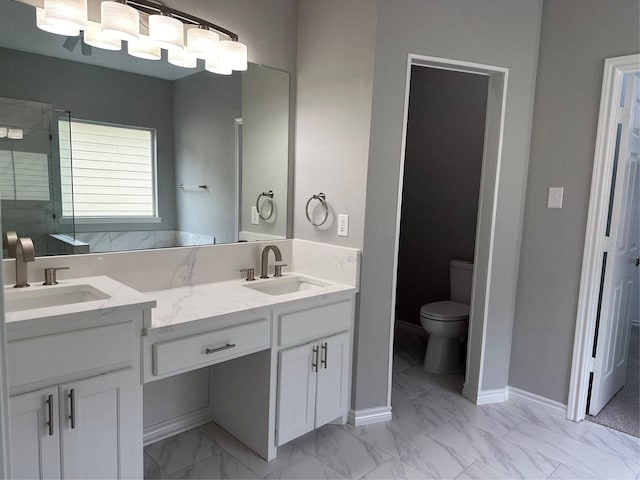 bathroom with double vanity, marble finish floor, and a sink