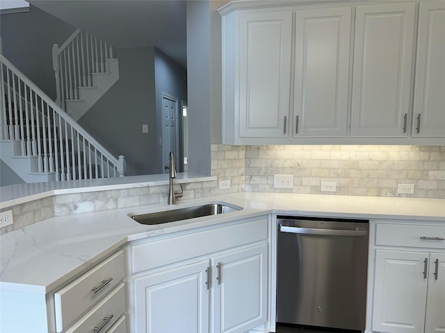 kitchen with white cabinetry, sink, and dishwasher