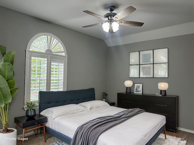 bedroom featuring lofted ceiling, ceiling fan, and baseboards