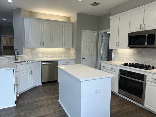 kitchen featuring white cabinetry, stainless steel oven, black gas cooktop, and backsplash