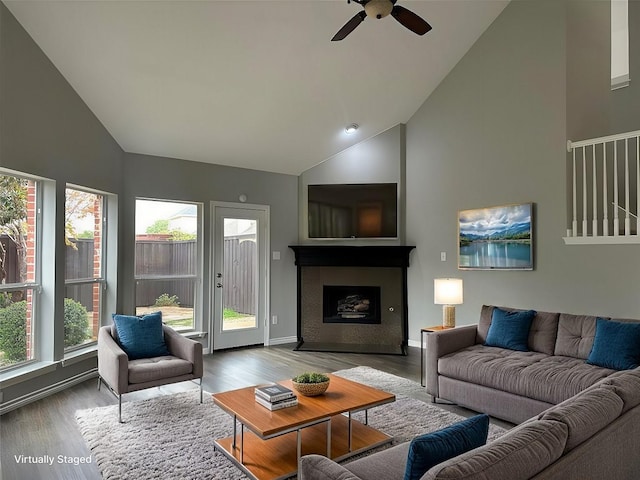 living room featuring high vaulted ceiling and wood finished floors