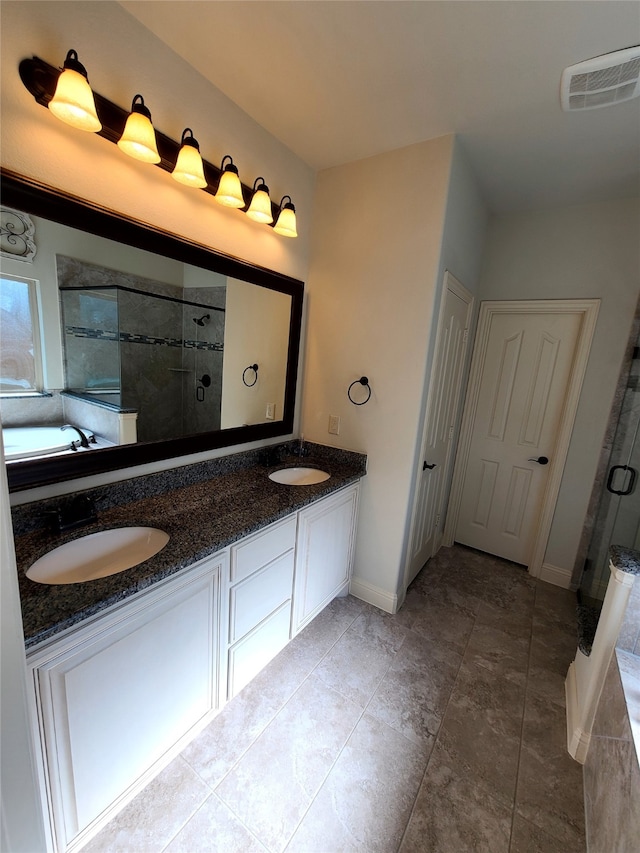 bathroom with vanity and shower with separate bathtub