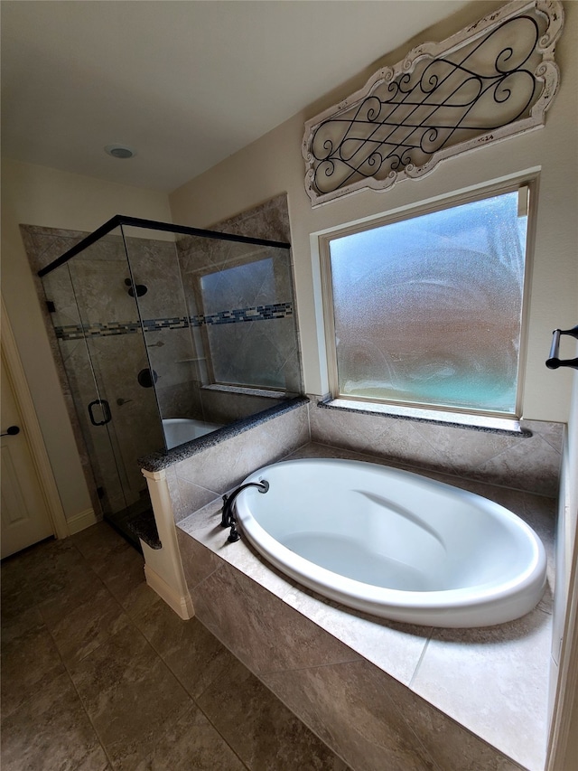 bathroom featuring separate shower and tub