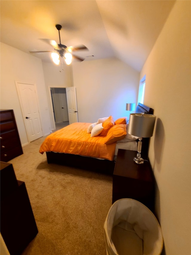 bedroom featuring lofted ceiling, light carpet, and ceiling fan