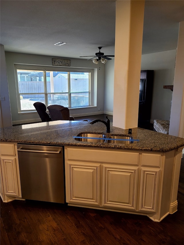 kitchen featuring sink, dishwasher, dark hardwood / wood-style floors, stone countertops, and kitchen peninsula