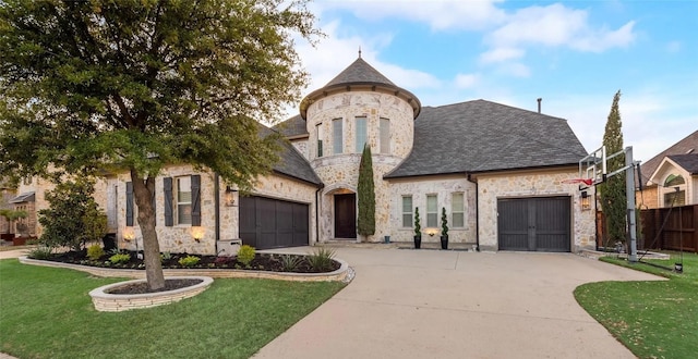 french provincial home with a garage and a front lawn