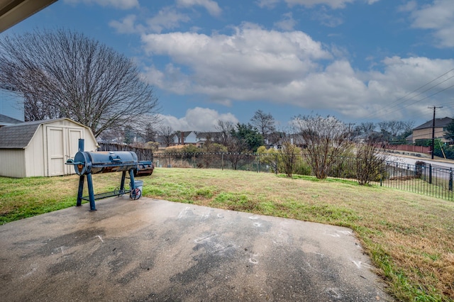 view of yard featuring a storage shed and a patio area