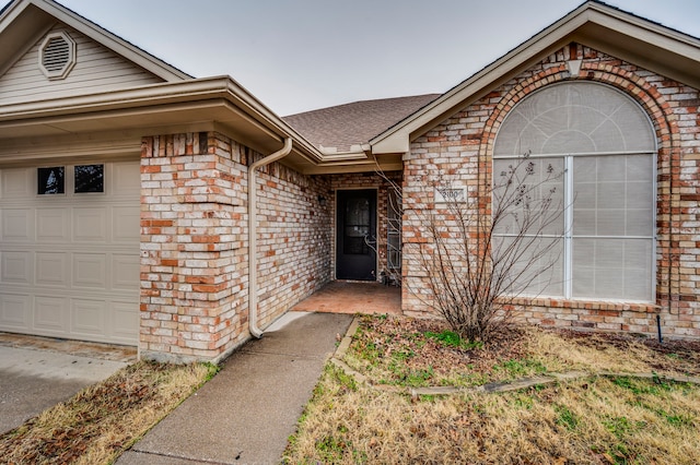 doorway to property featuring a garage