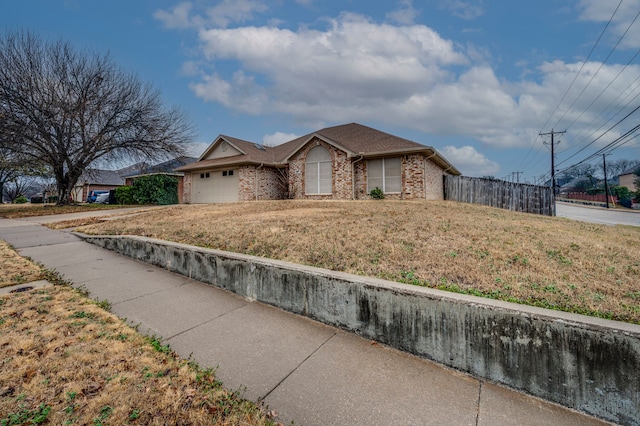 view of front of property with a garage and a front yard