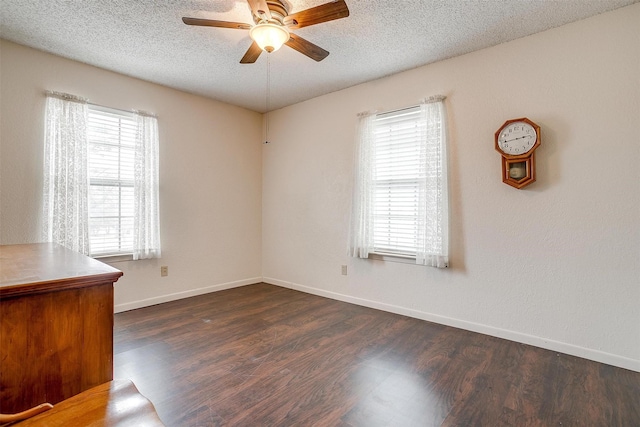 spare room with ceiling fan, dark hardwood / wood-style floors, and a textured ceiling