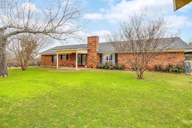 view of front of property with a patio and a front yard