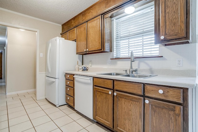 kitchen featuring tasteful backsplash, white appliances, sink, and a textured ceiling