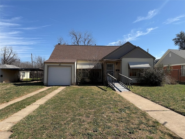 view of front of home featuring a garage, a front yard, and a carport