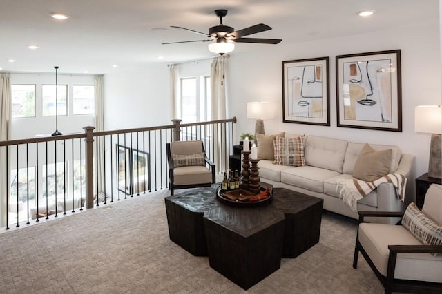 carpeted living room featuring ceiling fan