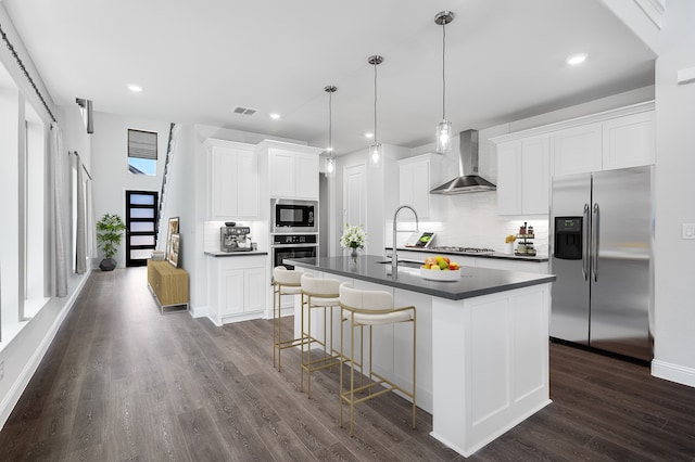 1533 Ginger Ln, Argyle, TX 76226 - kitchen with wall chimney exhaust hood, appliances with stainless steel finishes, dark countertops, decorative backsplash, and dark wood-type flooring