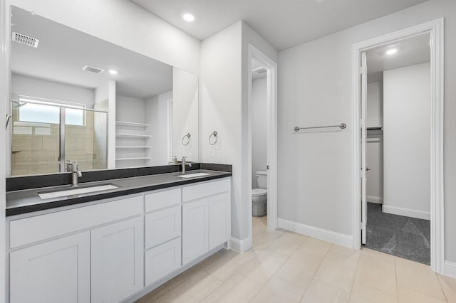 1533 Ginger Ln, Argyle, TX 76226 - bathroom featuring double vanity, toilet, a stall shower, baseboards, and recessed lighting