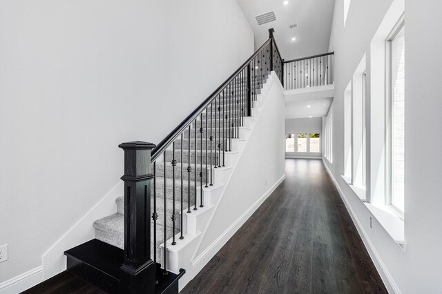 1533 Ginger Ln, Argyle, TX 76226 - stairway featuring wood finished floors, a towering ceiling, baseboards, and recessed lighting