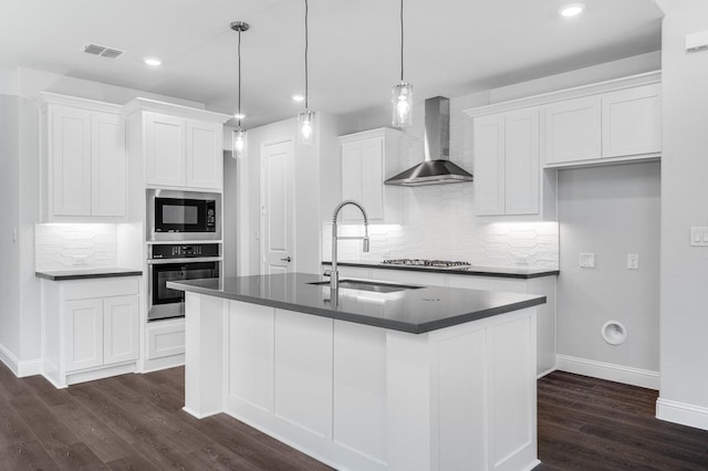 1533 Ginger Ln, Argyle, TX 76226 - kitchen featuring appliances with stainless steel finishes, wall chimney range hood, dark countertops, a sink, and dark wood-style floors
