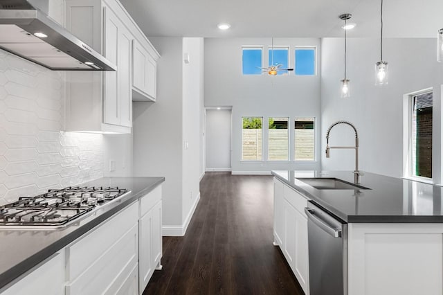 1533 Ginger Ln, Argyle, TX 76226 - kitchen featuring wall chimney range hood, a sink, appliances with stainless steel finishes, dark countertops, and recessed lighting