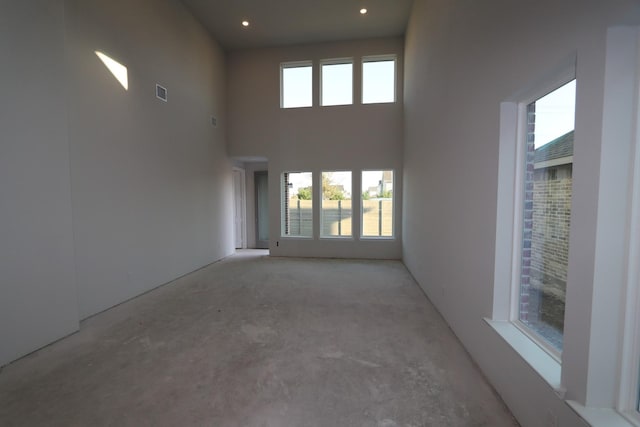 empty room featuring a towering ceiling