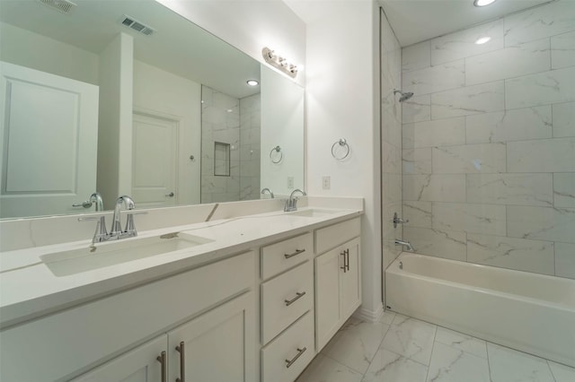 bathroom with tiled shower / bath and vanity