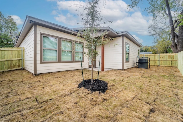 rear view of house featuring a lawn