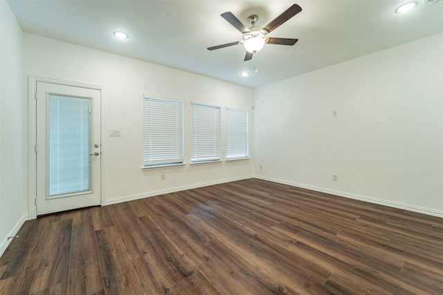 spare room featuring dark hardwood / wood-style floors and ceiling fan