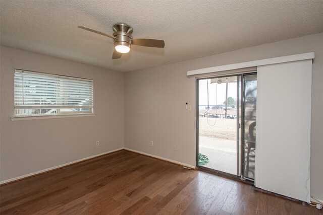 unfurnished bedroom with ceiling fan, a textured ceiling, and dark hardwood / wood-style flooring