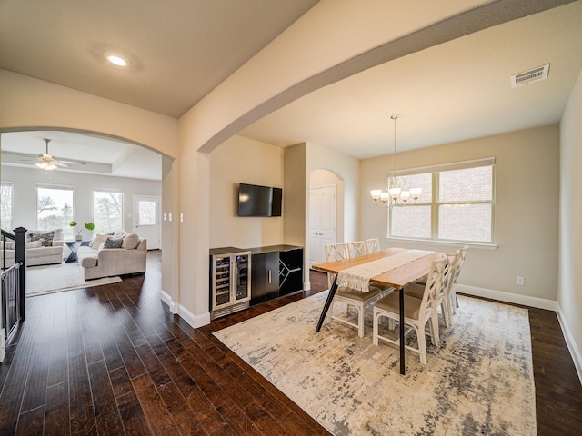 3124 Creek Meadow Dr, Anna, TX 75409 - dining area featuring wine cooler, arched walkways, visible vents, dark wood-type flooring, and baseboards