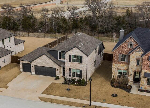 3124 Creek Meadow Dr, Anna, TX 75409 - view of front of house featuring a garage, driveway, stone siding, and fence