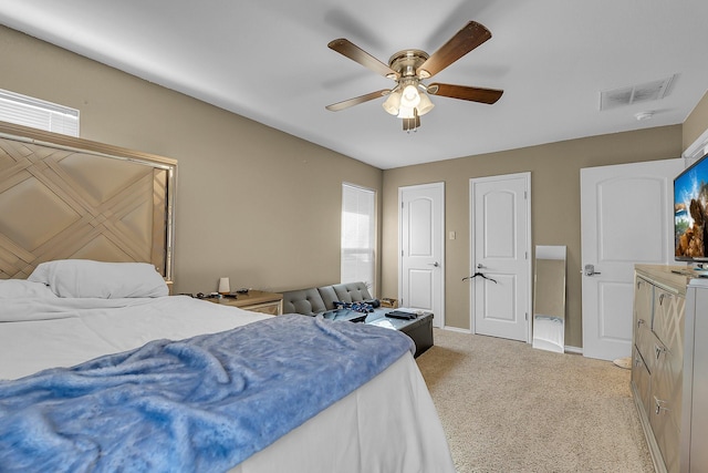 bedroom with light carpet and ceiling fan