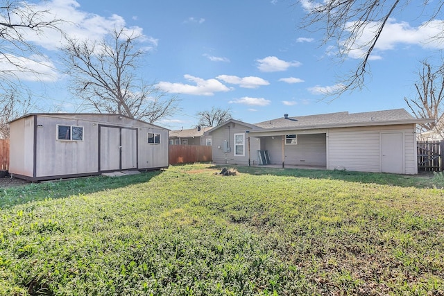 back of property with a lawn and a shed