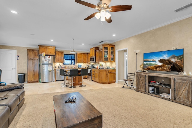 tiled living room with ornamental molding and ceiling fan